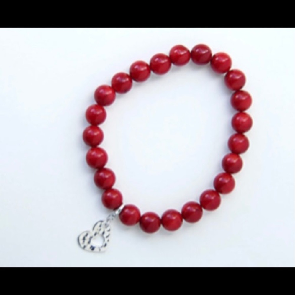Handcrafted Coral bead stretch bracelet with a sterling silver heart charm